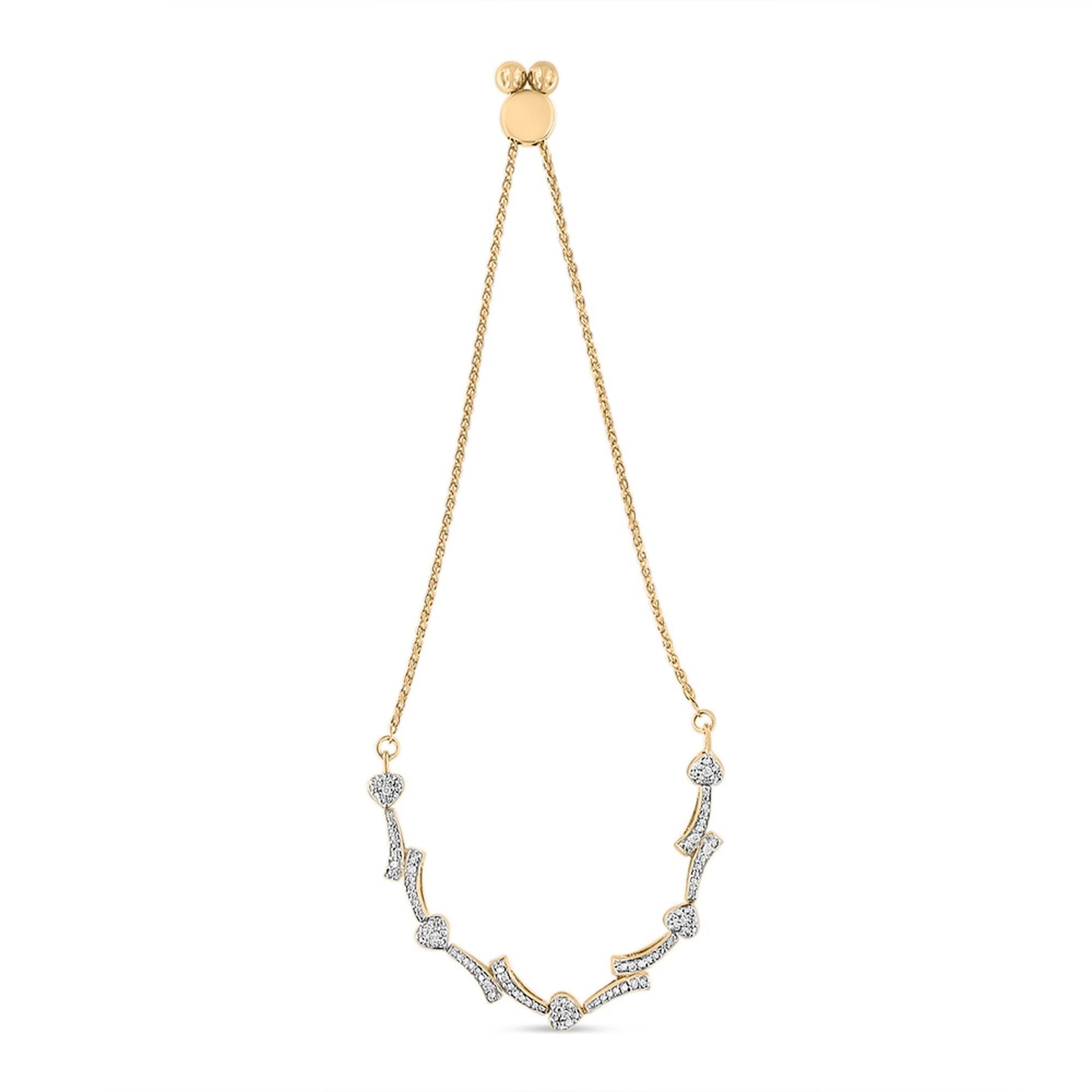 Yellow metal bracelet with curved segments and heart shapes set with small round white gemstones in a pave setting, shown from a front angle on a white background.