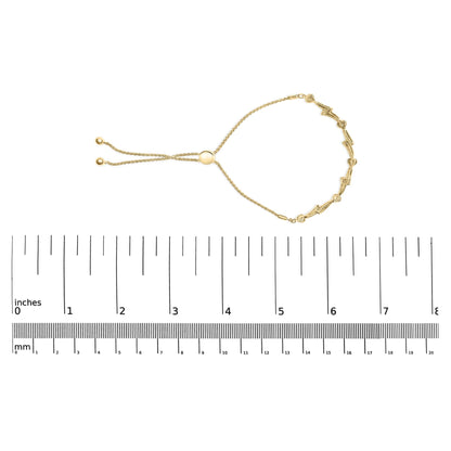 Yellow bracelet with white round gemstones in a pave setting, displayed on a ruler for size reference, front angle.