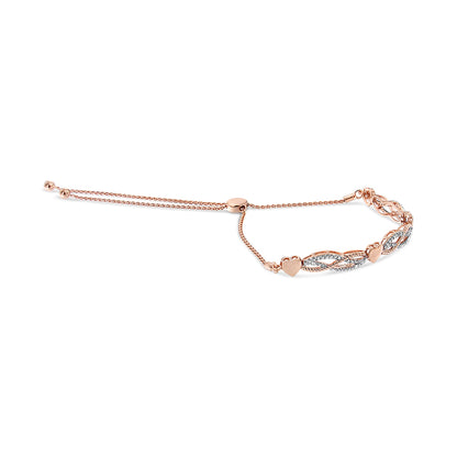 Rose-colored bracelet with heart shapes and intertwined design adorned with white pave-set round gemstones, shown from a side angle.
