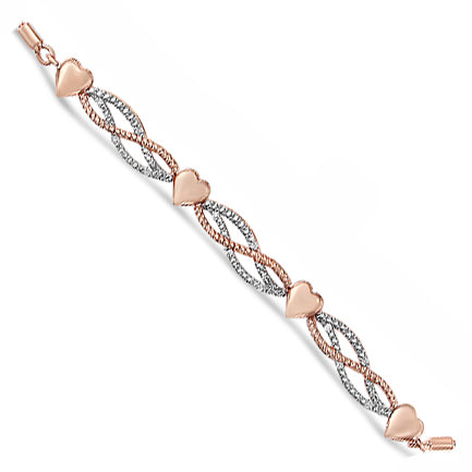 Close-up angled shot of a rose-colored bracelet featuring intertwined bands with white gemstones in a pave setting and four heart-shaped elements.