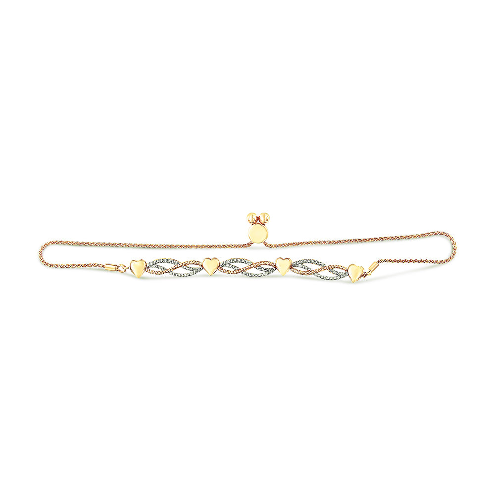 Yellow metal bracelet with connected heart shapes and intertwined sections set with white gemstones, viewed from above on a white background.