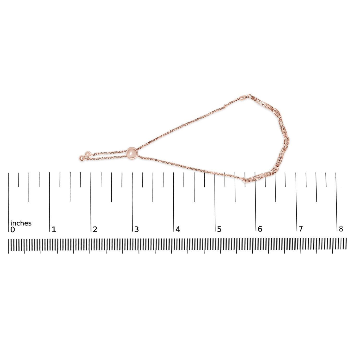 Rose-colored bracelet with a delicate chain and adjustable slider closure, featuring nine round white gemstones in a pave setting, lying flat on a ruler, top-down view.