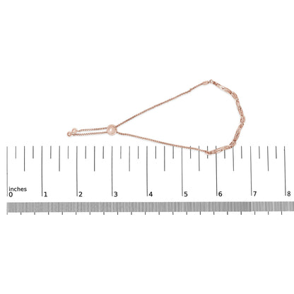 Rose-colored bracelet with a delicate chain and adjustable slider closure, featuring nine round white gemstones in a pave setting, lying flat on a ruler, top-down view.