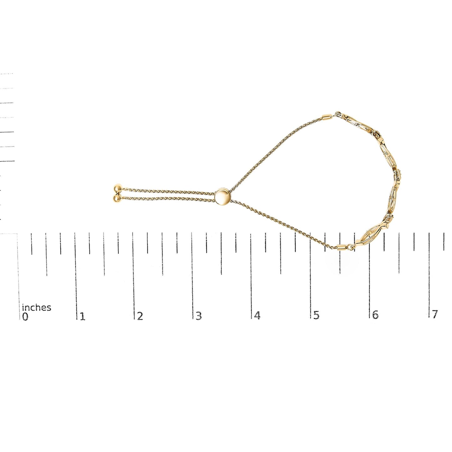 Yellow metal bracelet with round white gemstones in pave setting, displayed flat on a ruler for size reference, top-down view.