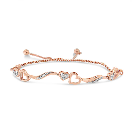 Rose metal bracelet with alternating open heart shapes and wave designs set with white round pave gemstones, shown in a front angled view.