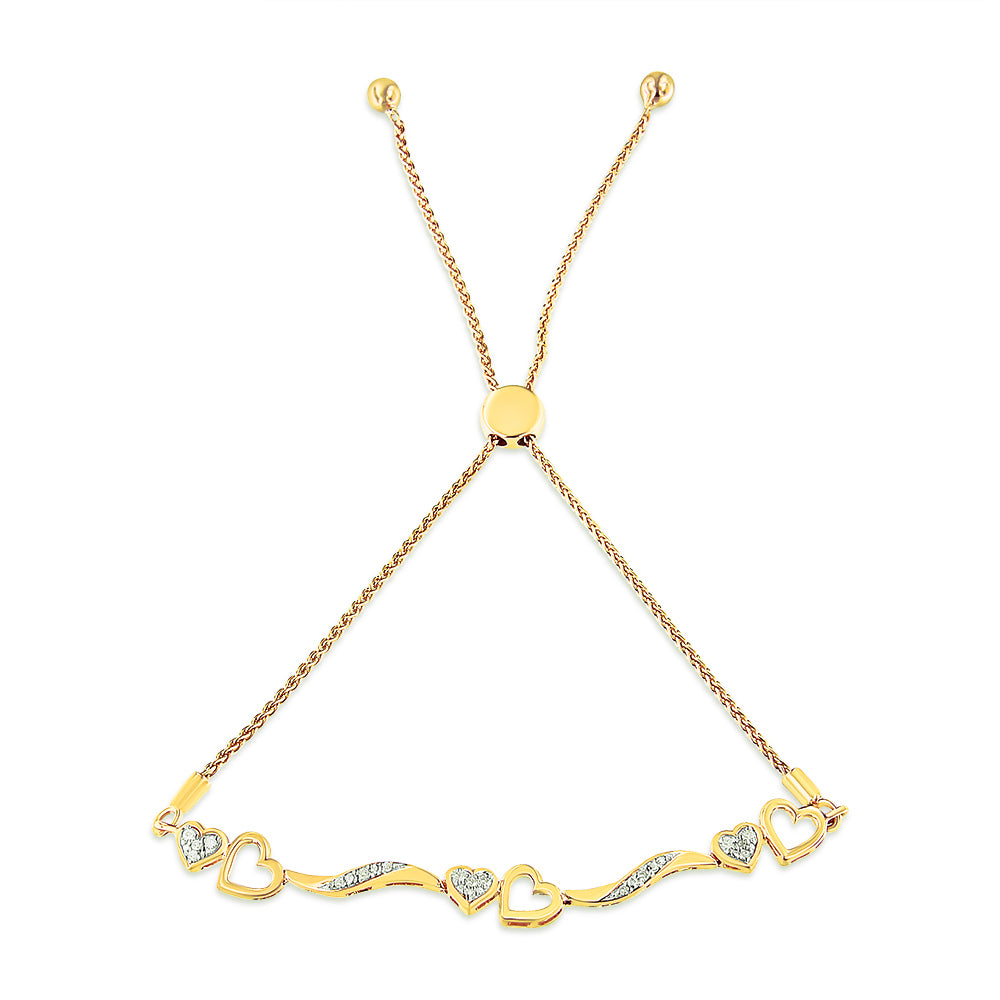 Yellow metal bracelet with alternating solid and open heart shapes set with small white gemstones, shown flat from a top-down angle.