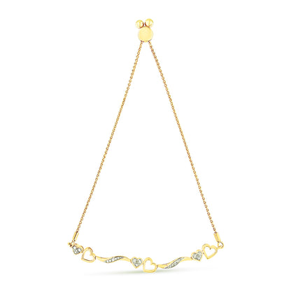 Yellow metal bracelet with heart-shaped motifs and white gemstones in pave setting, shown from a front angle on a white background.