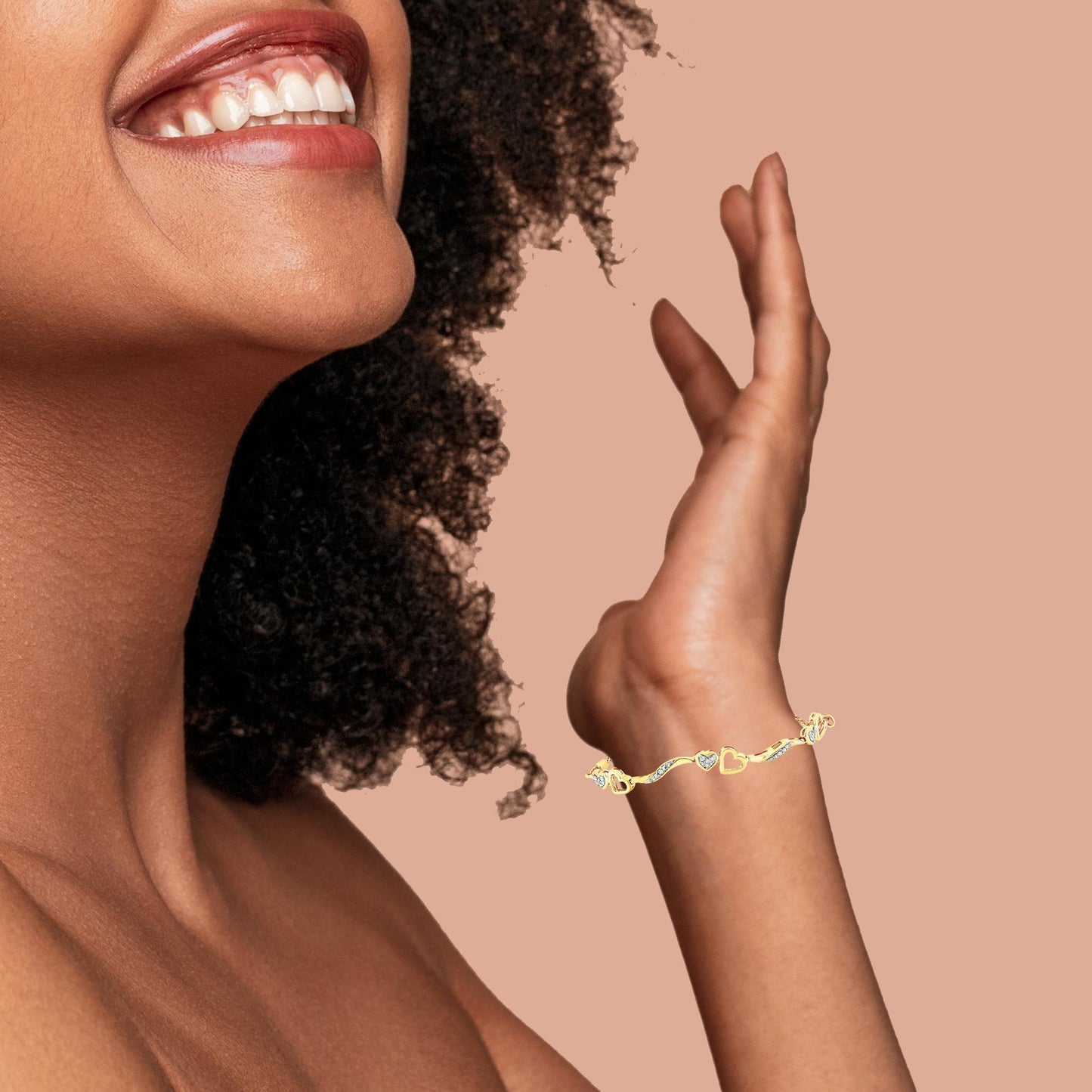 Yellow metal bracelet with heart-shaped elements and white gemstones in pave setting, shown on a model's wrist with an upward hand pose, angled side view.