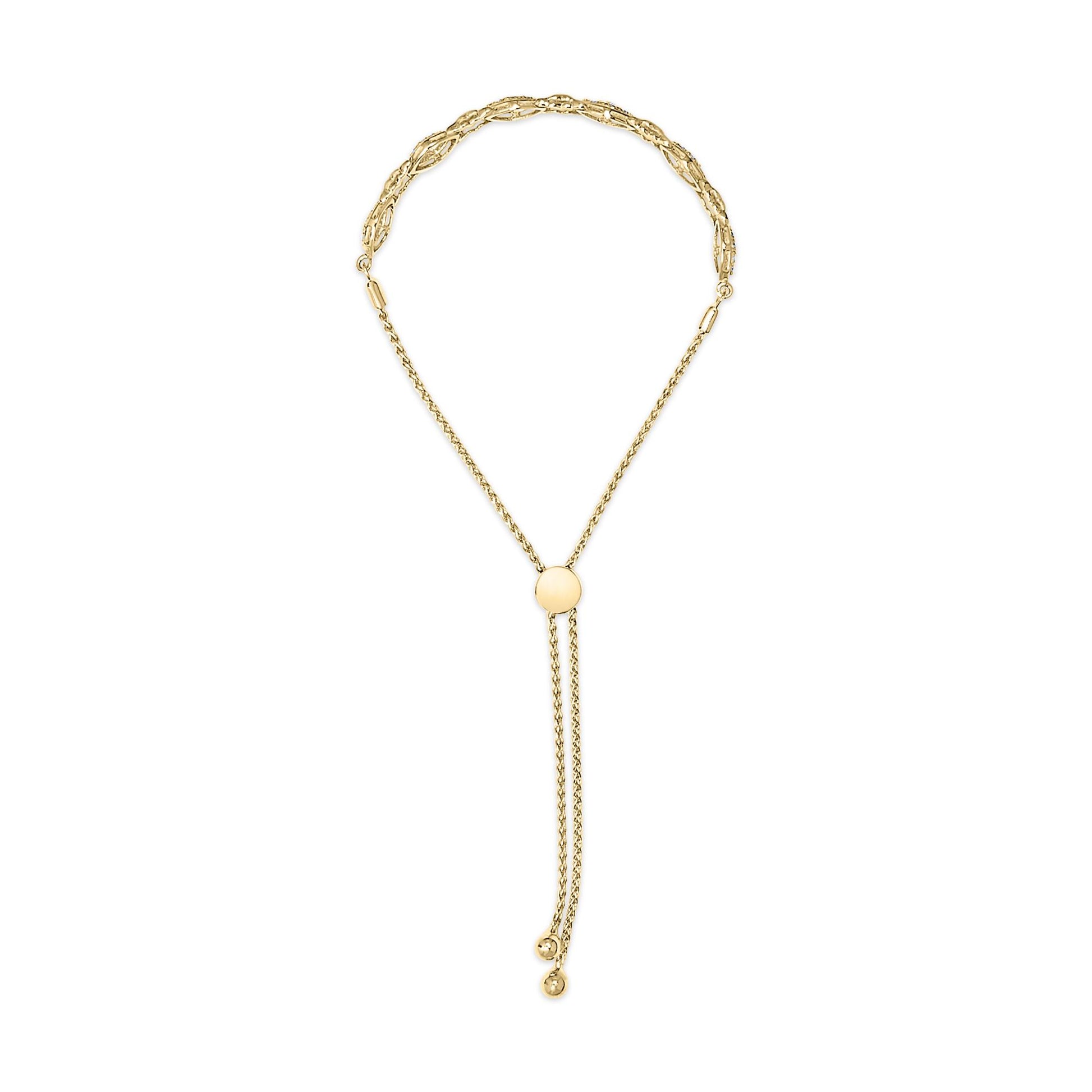 Yellow metal bracelet with a round, pave-set white gemstones detail, shown from a top-down angle.