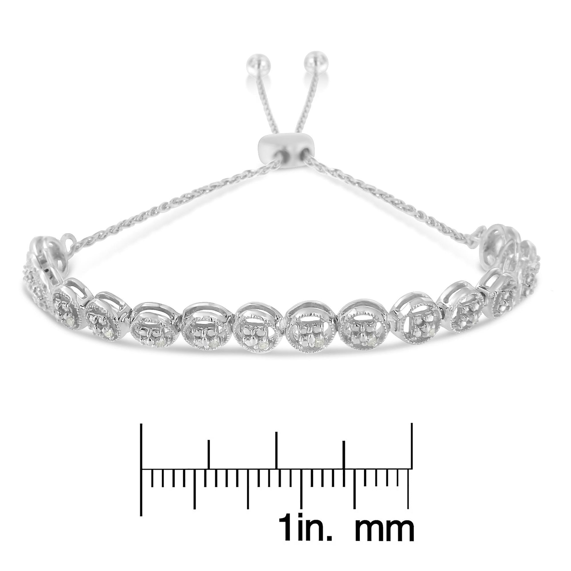 White metal bracelet with round white gemstones in prong settings, shown from a front angle on a ruler for size reference.