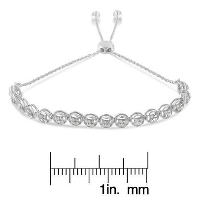 White metal bracelet with round white gemstones in prong settings, displayed flat with adjustable chain ends, shown above a ruler for size reference, angled front view.