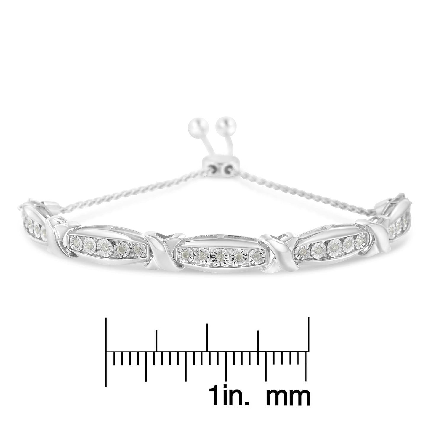 White metal bracelet with multiple sections set with round white gemstones in miracle setting, photographed from front on with a ruler below for size reference.