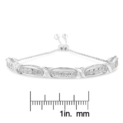 White metal bracelet with multiple sections set with round white gemstones in miracle setting, photographed from front on with a ruler below for size reference.