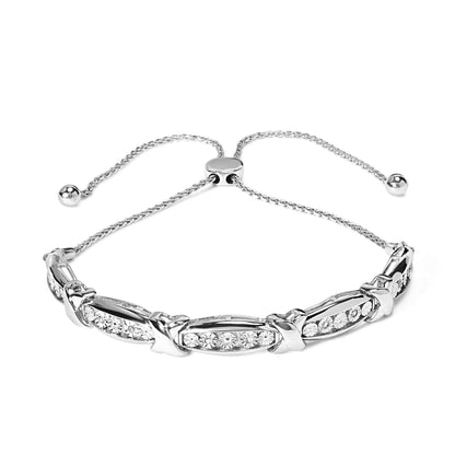 Front angle of a white metal bracelet featuring a sliding adjustable chain with round white gemstones set in a miracle setting.
