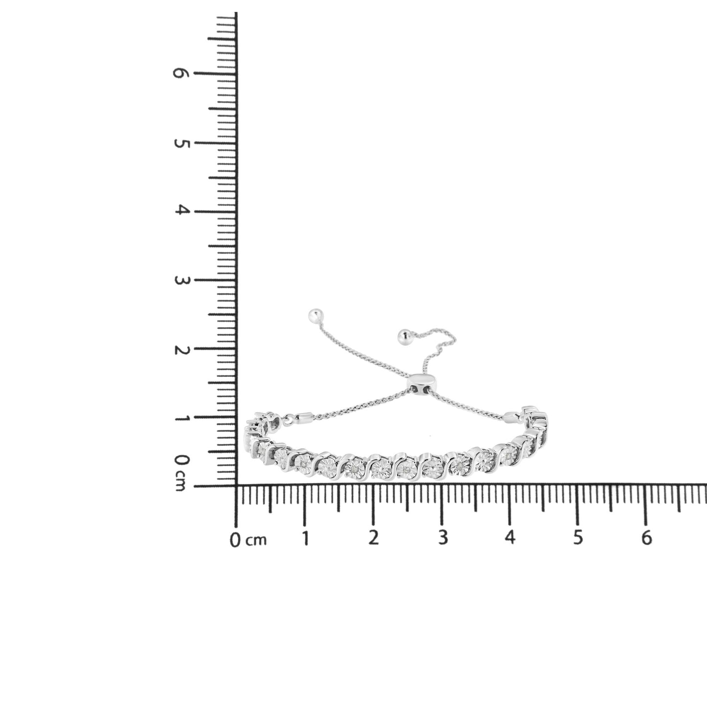 White metal bracelet with round white gemstones in miracle setting, displayed flat on a ruler for size reference, top-down angle.