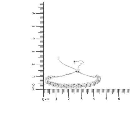 White metal bracelet with round white gemstones in miracle setting, displayed flat on a ruler for size reference, top-down angle.