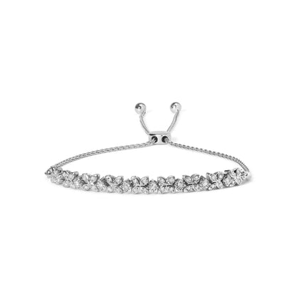White metal bracelet with alternating floral motifs and round white gemstones, viewed from a front angle on a white background.