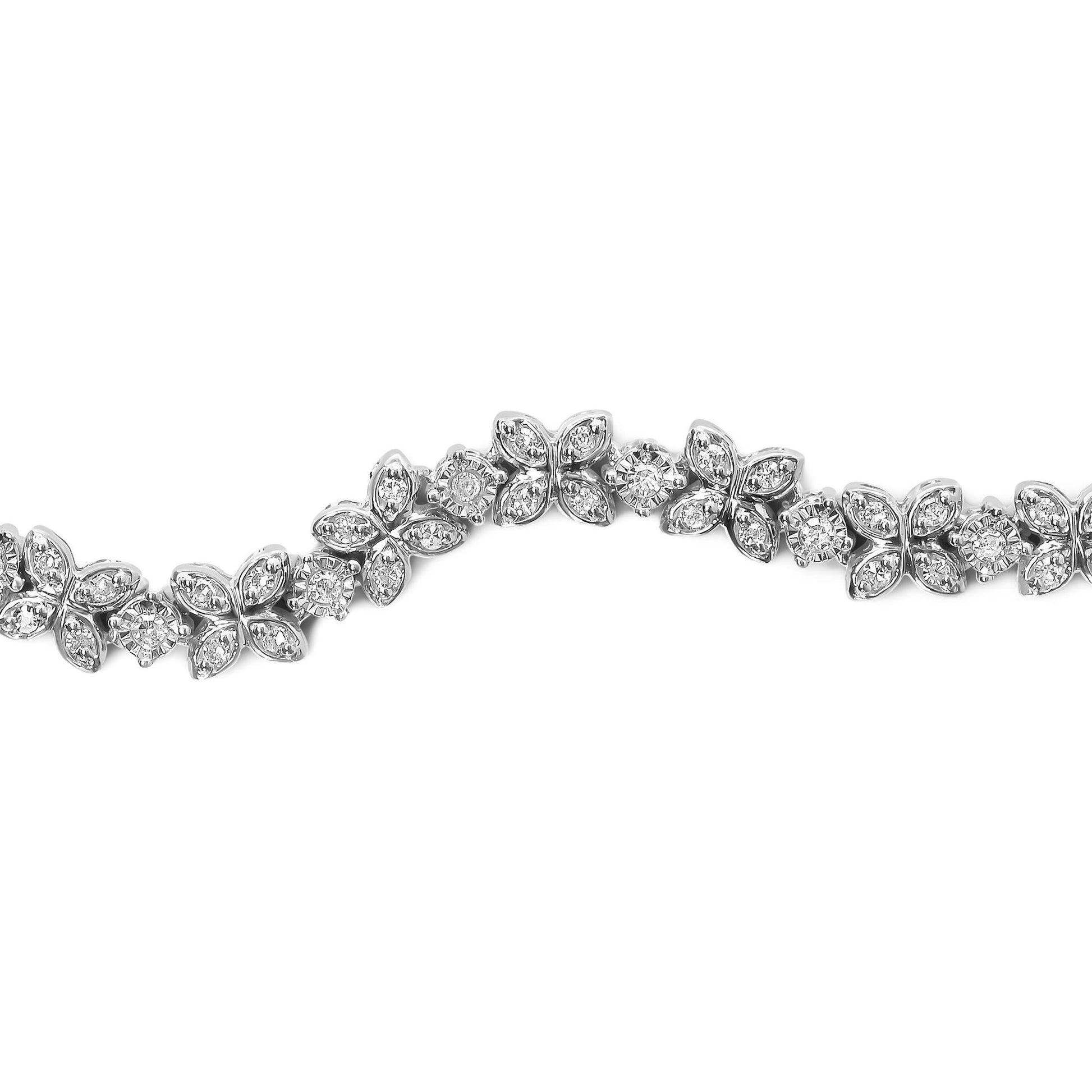 Close-up front angle of a white metal bracelet featuring alternating floral motifs with small white gemstones in miracle settings and round white gemstones in prong settings.