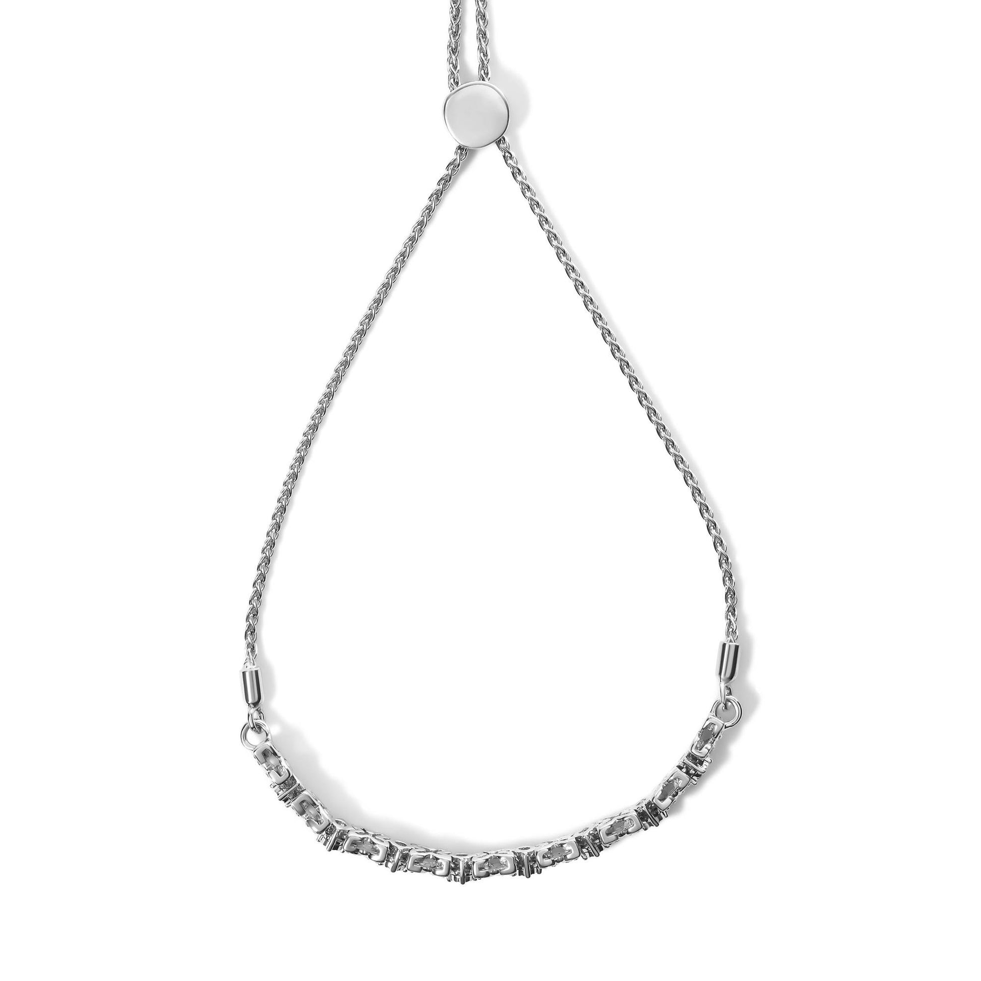 White metal bracelet with alternating sections of round white gemstones in miracle and prong settings, shown from a top-down angle.