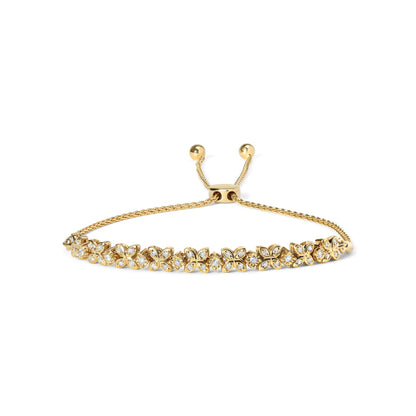 Yellow metal bracelet with flower-shaped links featuring white round gemstones in prong and miracle settings, shown from a front angle on a white background.