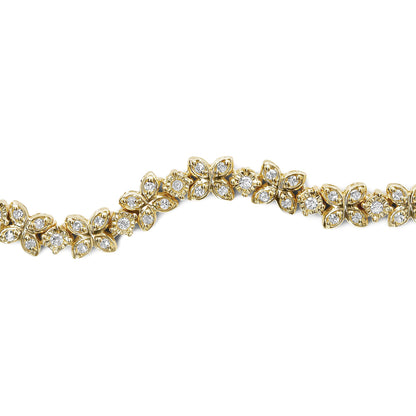 Yellow metal bracelet with alternating butterfly and round floral motifs set with white round gemstones, shown in a close-up shot on a white background.