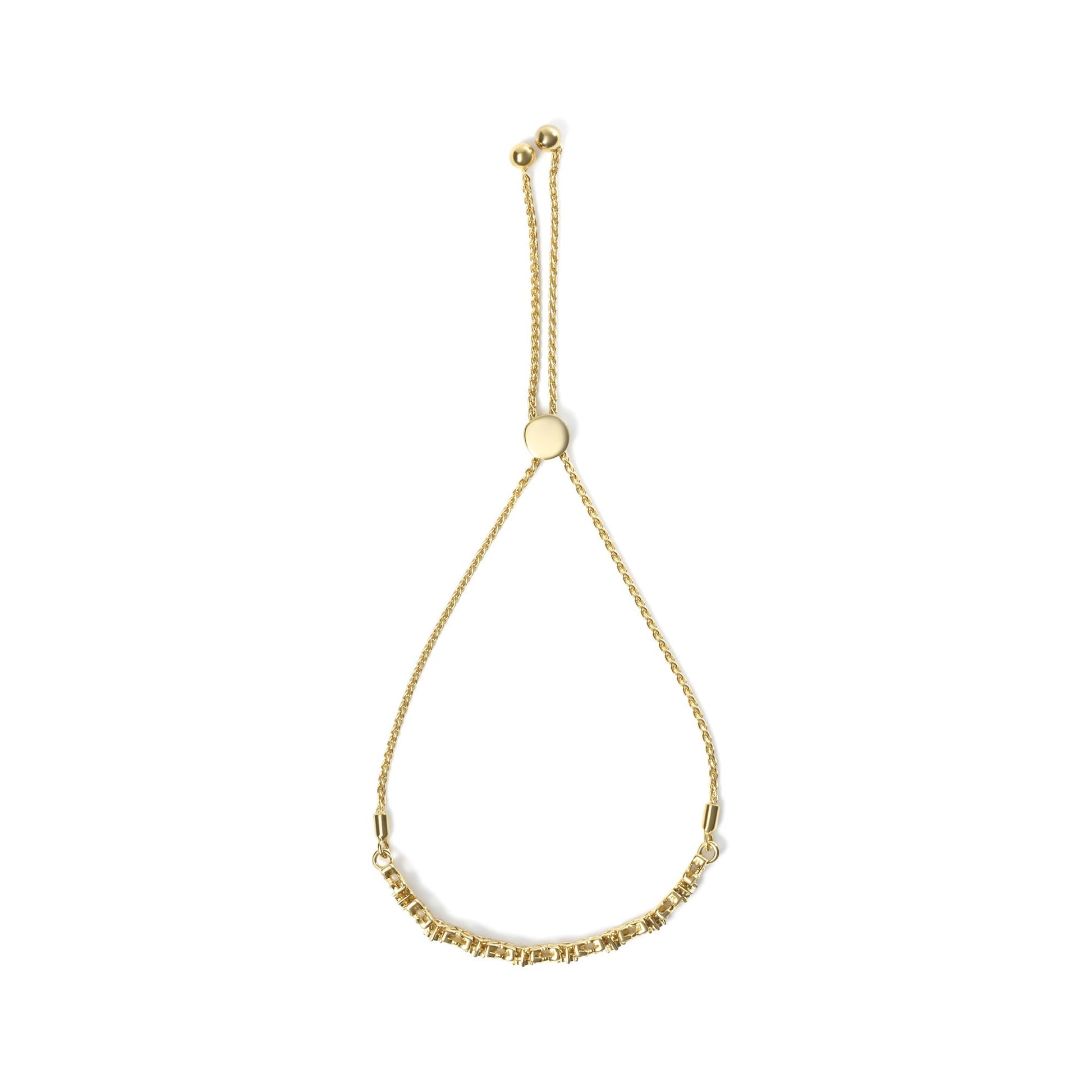 Yellow metal bracelet with a row of round white gemstones in prong and miracle settings, displayed flat from above.