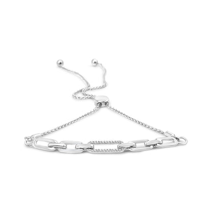 White metal bracelet with chain links and one link encrusted with small white gemstones, shown from a slightly elevated angle.
