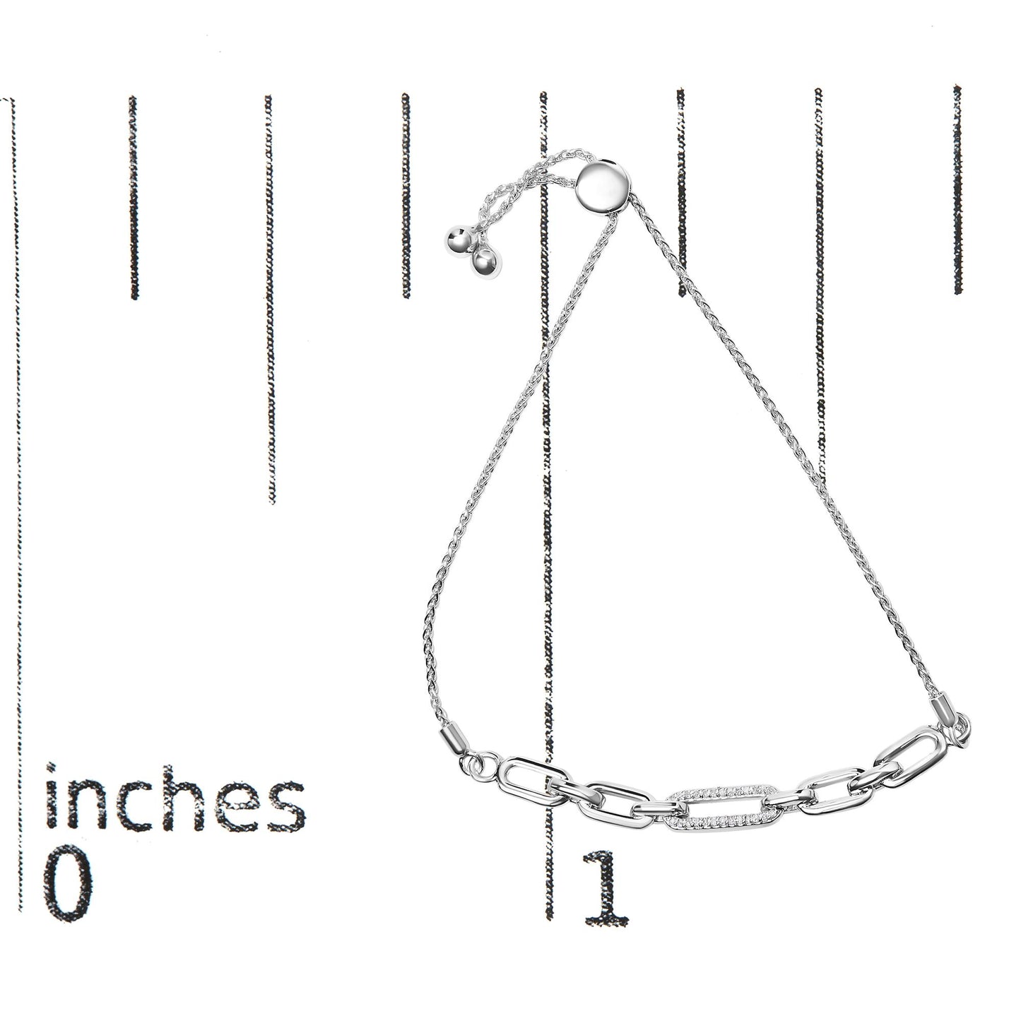 White metal bracelet with chain links, one link adorned with small white gemstones, shown on a ruler for size reference, top view.