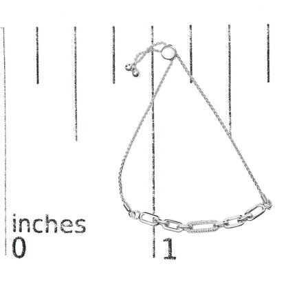 White metal bracelet with chain links, one link adorned with small white gemstones, shown on a ruler for size reference, top view.