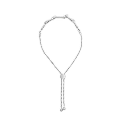 White metal bracelet with a round slider and chain tassels, shown from a top-down angle.