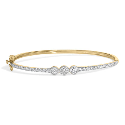 Yellow metal bracelet with a row of white gemstones along the top band and three larger white gemstones in the center, shown in a front-facing angle on a white background.