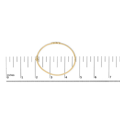 Yellow metal bracelet with round white gemstones in prong settings, shown on a scale from a top-down angle.