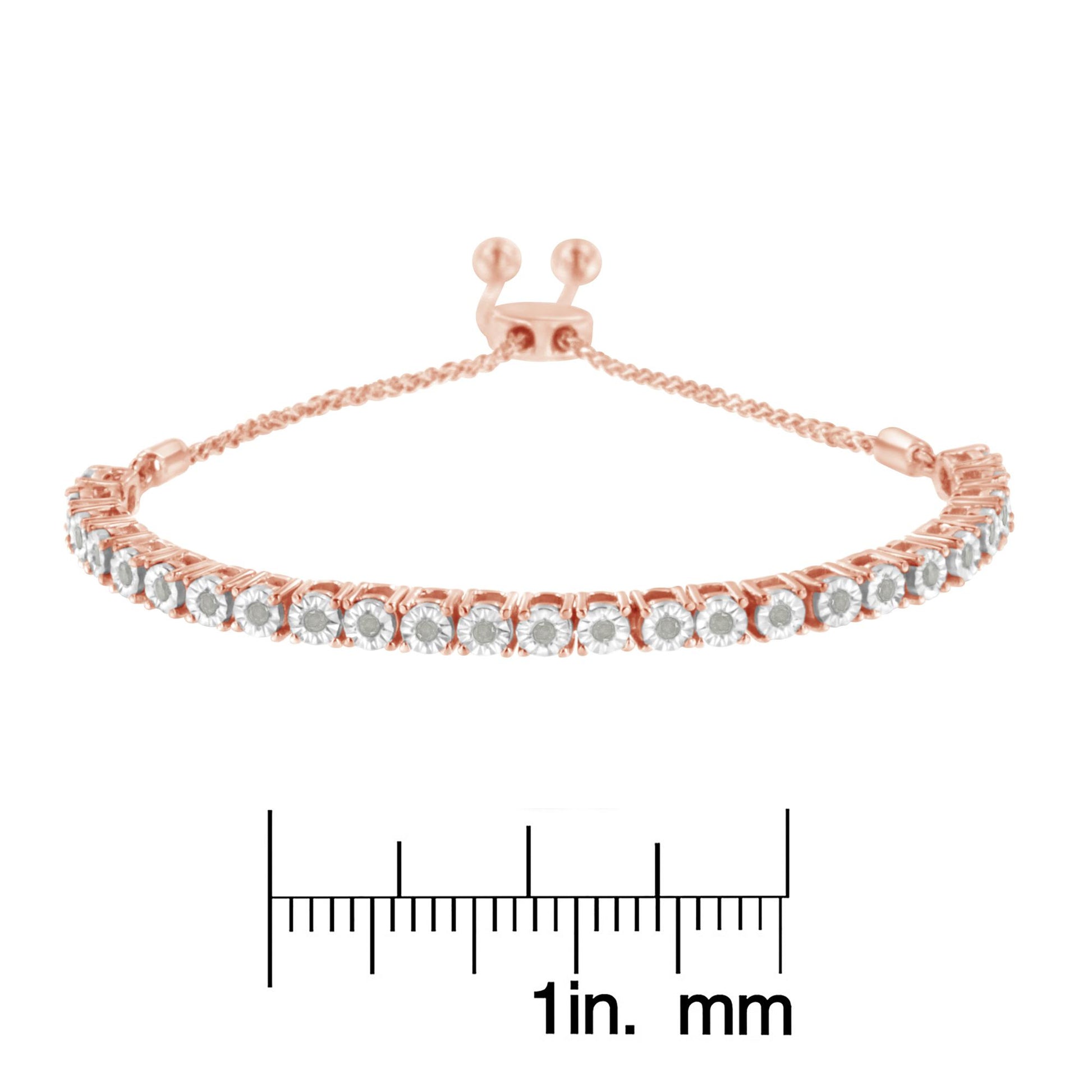 Rose metal bracelet with round white gemstones in miracle setting, shown from front angle on a ruler for size reference.
