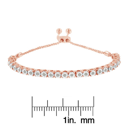 Rose metal bracelet with round white gemstones in miracle setting, shown from front angle on a ruler for size reference.