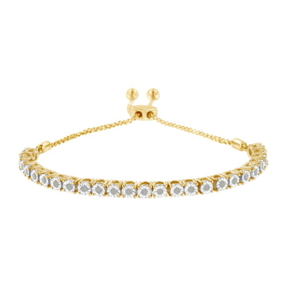 Yellow metal bracelet with a row of white round gemstones in miracle settings, photographed from the front at a slight downward angle.