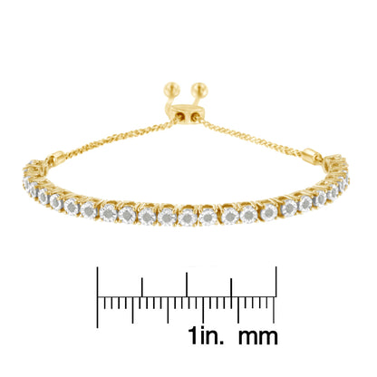 Yellow bracelet with a row of round white gemstones in miracle settings, shown from a front angle with a ruler for size reference.