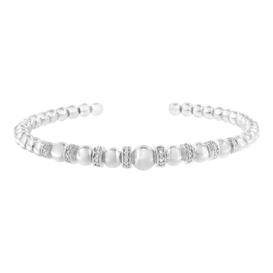 White metal bracelet with rounded beads and round pave-set white gemstones, shown at a slight angle.