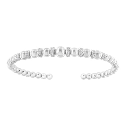 Open white metal bracelet viewed from the front, featuring round pave-set white gemstones alternating with polished metal beads.