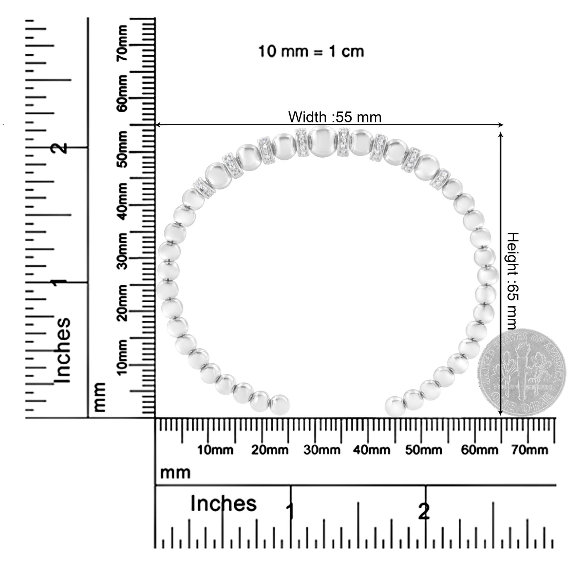 White metal bracelet with round white gemstones in pave settings, shown from a top-down view on a ruler and scale for size reference.