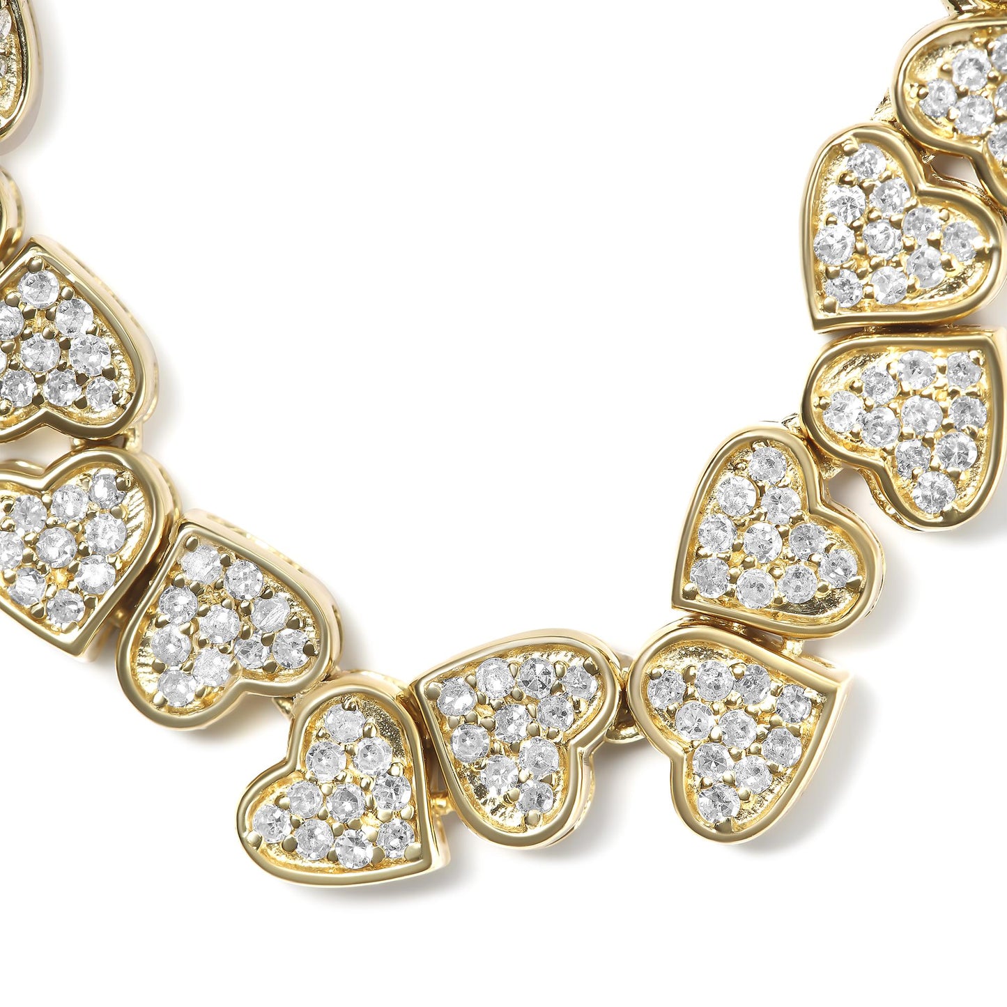 Close-up of a yellow metal bracelet with heart-shaped links, each paved with round white gemstones, shown from an angled top view.