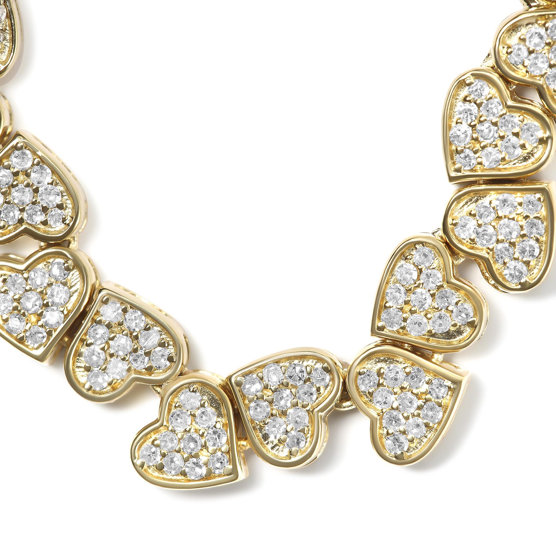 Close-up of a yellow metal bracelet with heart-shaped links, each paved with round white gemstones, shown from an angled top view.