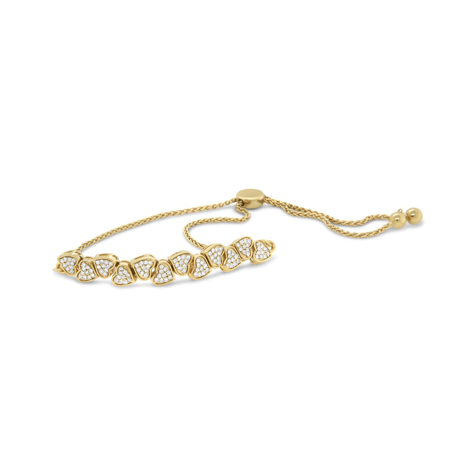 Yellow metal bracelet with heart-shaped elements featuring round white gemstones in a pave setting, shown from a side angle on a white background.