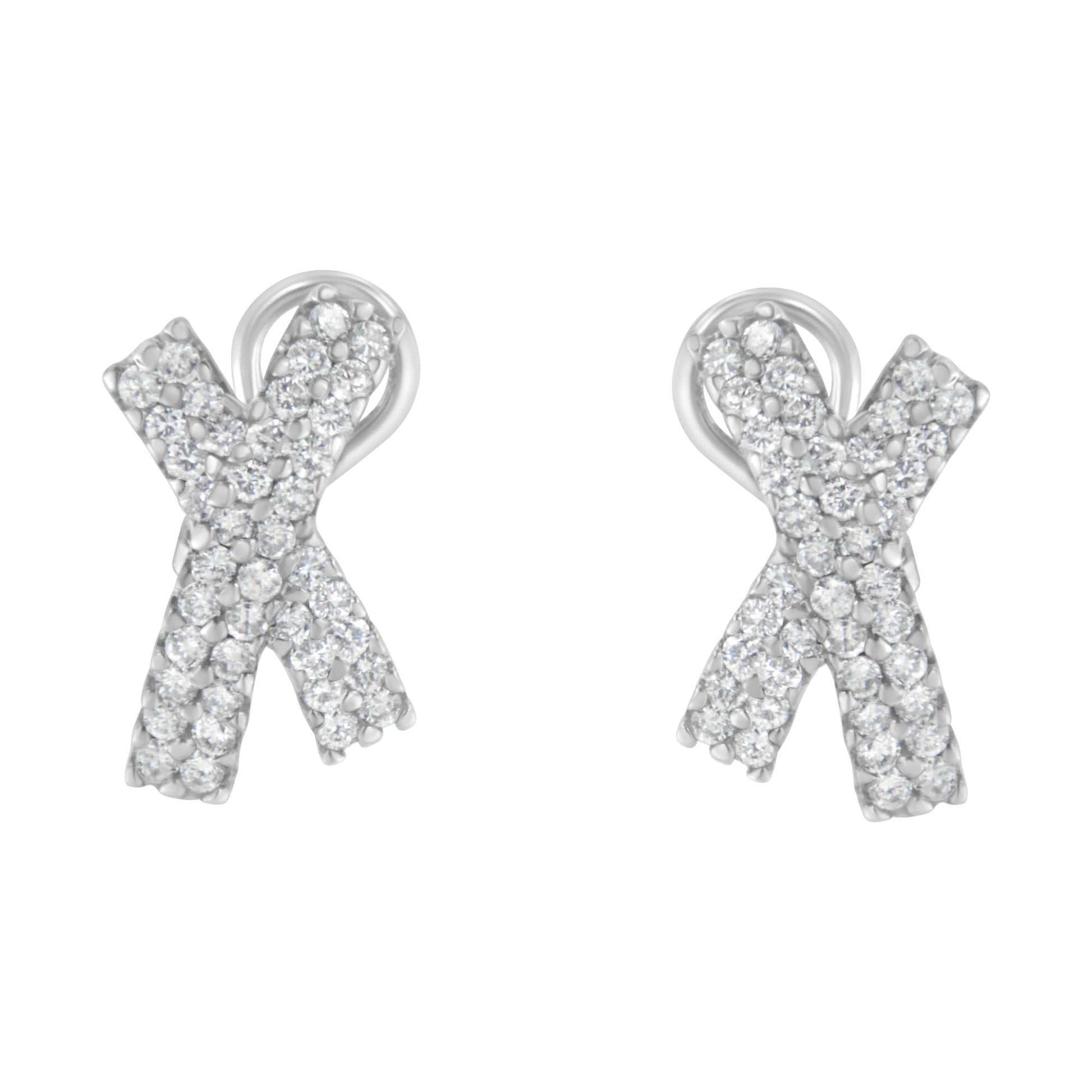 Front view of white metal earrings shaped like an 'X' covered with round white gemstones in prong settings.