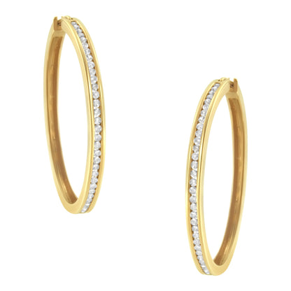 Pair of yellow metal hoop earrings with round white gemstones set in a channel along the front, shown from a slightly angled front view.