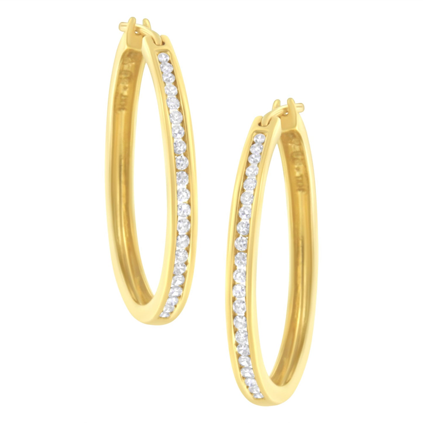 Pair of yellow metal oval hoop earrings with a channel setting of round white gemstones, shown from a front angle.