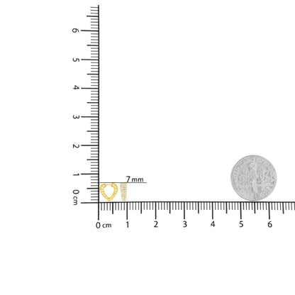 Top down view of a pair of yellow metal earrings on a ruler for size reference, one shaped like an open heart with channel set white round gemstones and the other a tapered bar with channel set white baguette gemstones.