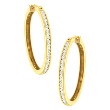 Pair of yellow hoop earrings with channel-set round white gemstones, shown at a slight angle.