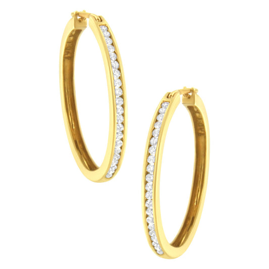 Pair of yellow hoop earrings with channel-set round white gemstones, shown at a slight angle.