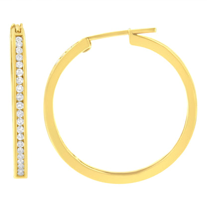 Front and side view of a yellow metal hoop earring with a channel set row of round white gemstones, shown against a white background.