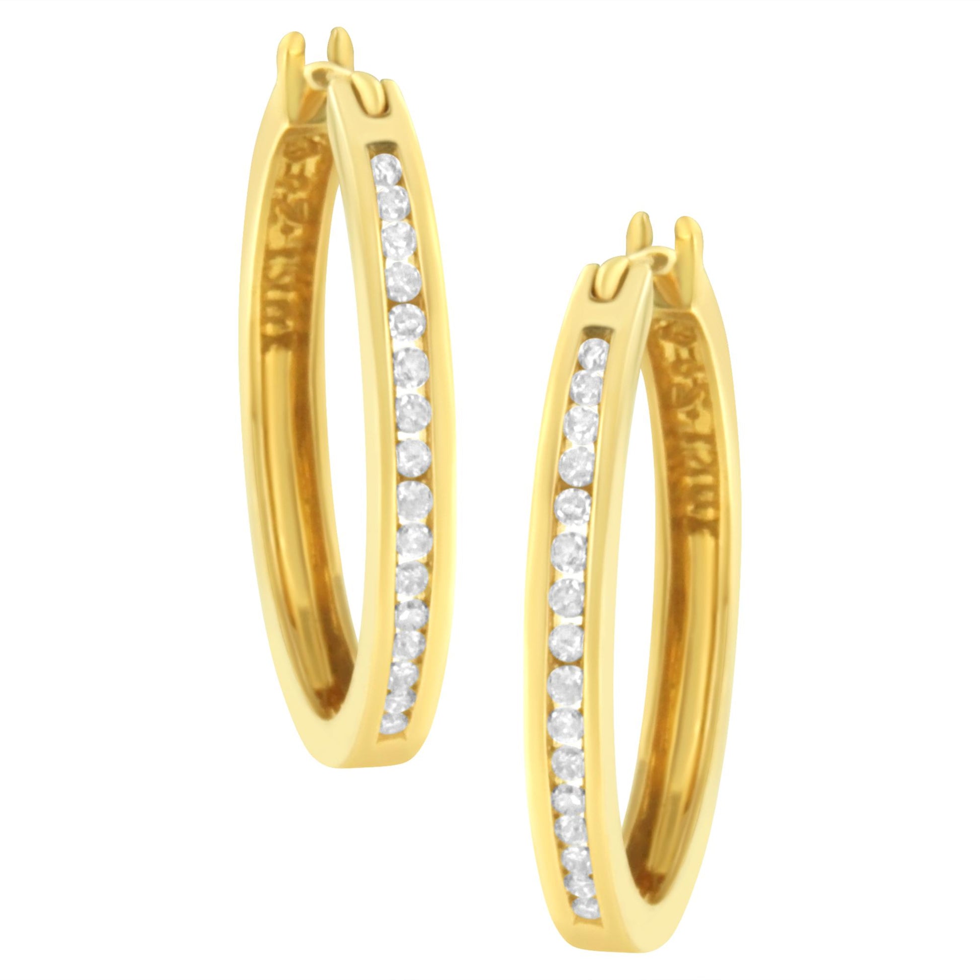 Pair of yellow metal hoop earrings with white round gemstones in channel setting, shown from a front angled view.